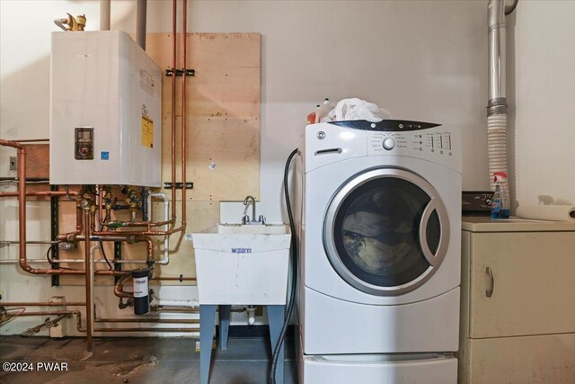 1075 Owego Tpke, Honesdale, PA 18431 - washroom featuring tankless water heater and washer and clothes dryer