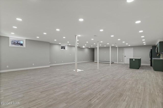 1075 Owego Tpke, Honesdale, PA 18431 - finished basement with light wood finished floors and freestanding refrigerator
