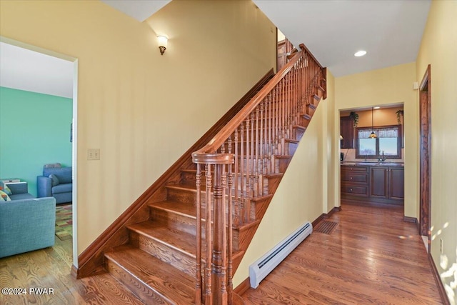 1075 Owego Tpke, Honesdale, PA 18431 - stairs with baseboard heating, wood finished floors, and recessed lighting