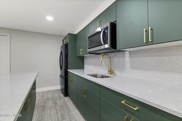 1075 Owego Tpke, Honesdale, PA 18431 - kitchen featuring stainless steel microwave, green cabinets, freestanding refrigerator, light wood-style floors, and recessed lighting