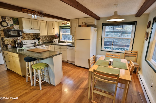 150 N Lake Dr, Dingmans Ferry, PA 18328 - kitchen with white appliances, under cabinet range hood, baseboard heating, dark countertops, and a peninsula