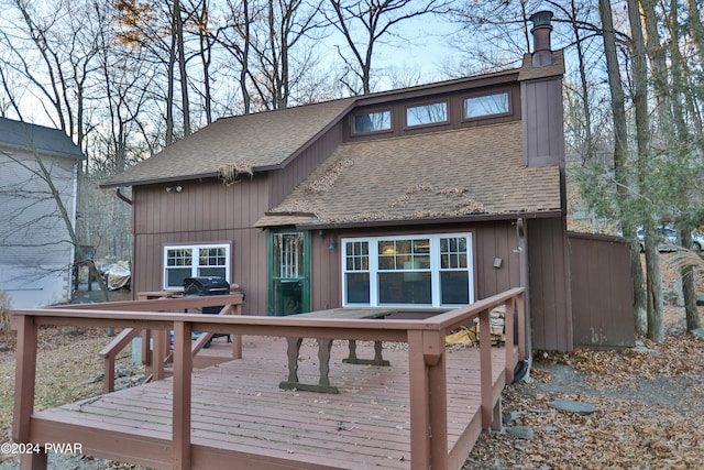 rear view of house with a wooden deck