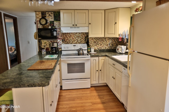 150 N Lake Dr, Dingmans Ferry, PA 18328 - kitchen featuring white appliances, exhaust hood, dark countertops, and light wood finished floors