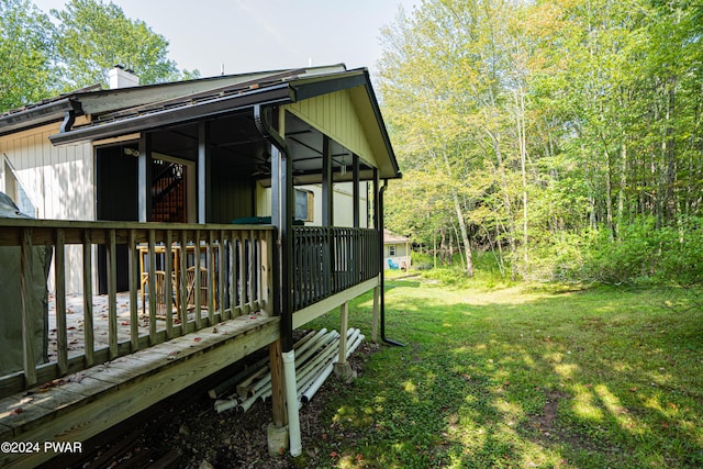 view of side of home with a lawn and a wooden deck