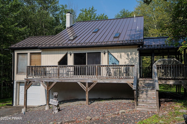 rear view of property featuring a garage