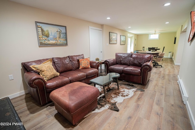 living room with a baseboard radiator and light hardwood / wood-style floors