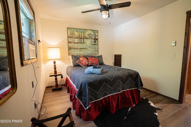 bedroom with ceiling fan and hardwood / wood-style floors