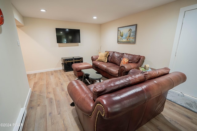 living room featuring a baseboard radiator and light wood-type flooring