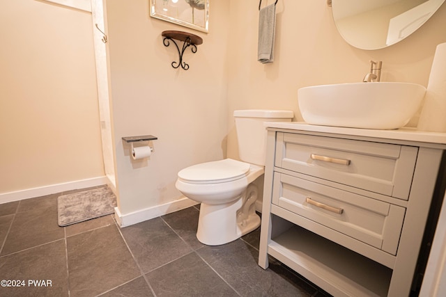 bathroom with tile patterned floors, vanity, and toilet