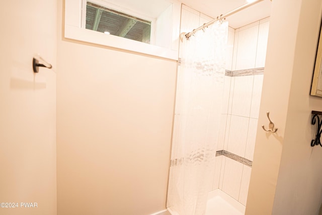 bathroom with tiled shower