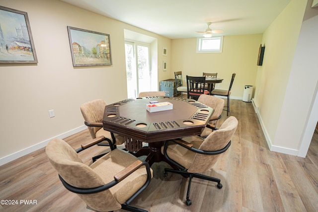 dining space with light hardwood / wood-style flooring and ceiling fan