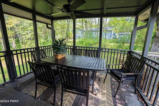 sunroom / solarium featuring ceiling fan