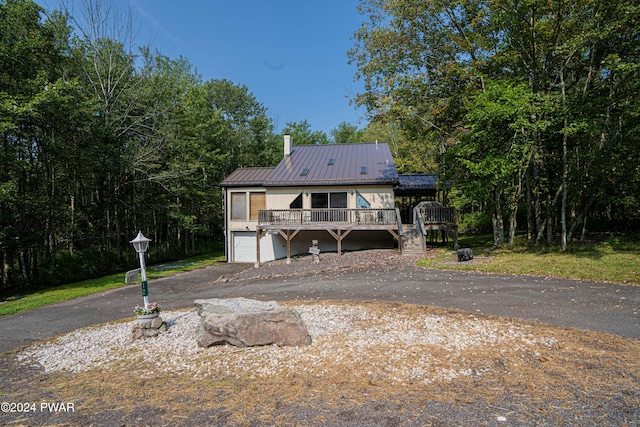 view of front of property with a garage and a wooden deck