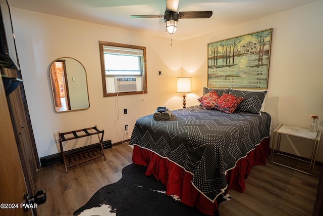 bedroom featuring hardwood / wood-style flooring, ceiling fan, and cooling unit