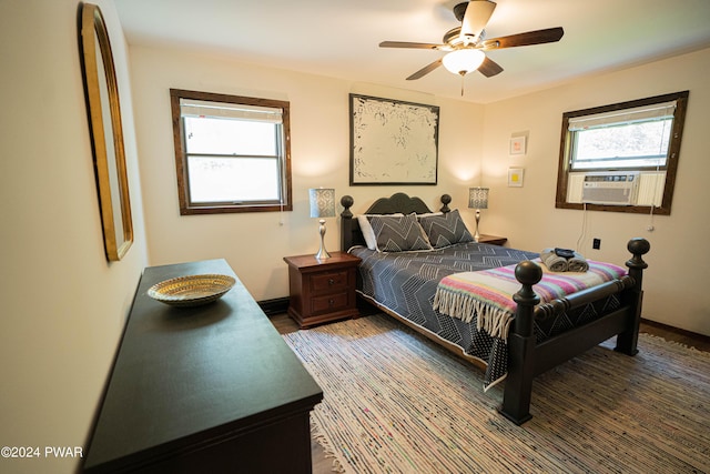 bedroom with ceiling fan and cooling unit