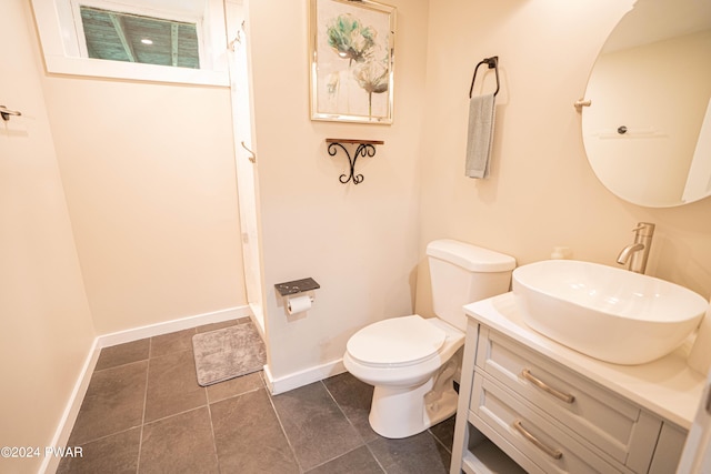 bathroom featuring tile patterned floors, vanity, and toilet