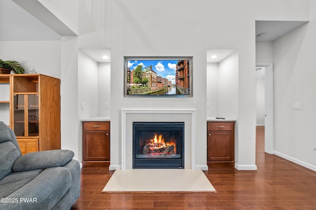 309 Braeburn Path, Matamoras, PA 18336 - living room featuring recessed lighting, baseboards, a glass covered fireplace, and dark wood-type flooring