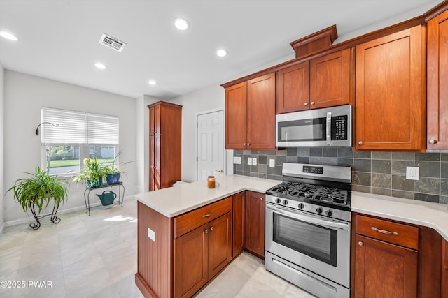 309 Braeburn Path, Matamoras, PA 18336 - kitchen with visible vents, light countertops, a peninsula, and stainless steel appliances