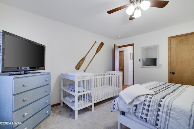 bedroom featuring ceiling fan and light colored carpet