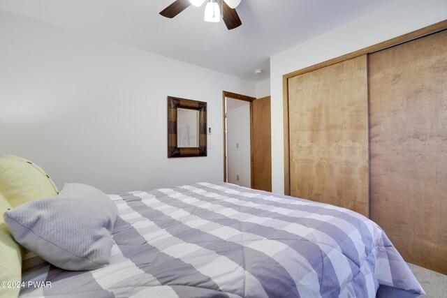 bedroom featuring ceiling fan and a closet