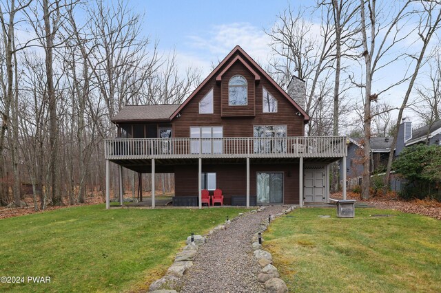 back of house featuring a deck and a yard