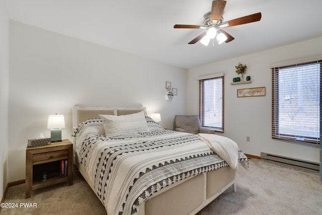 carpeted bedroom with ceiling fan and a baseboard radiator