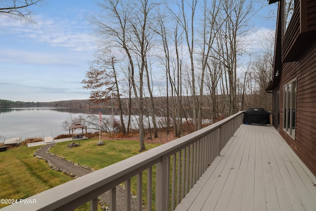 deck featuring a water view and a lawn