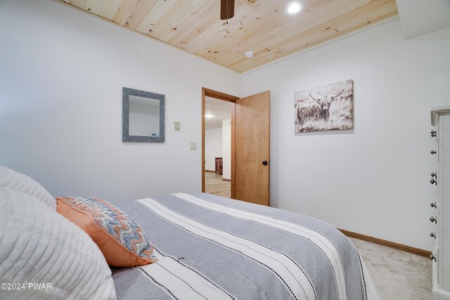 carpeted bedroom featuring ceiling fan and wooden ceiling