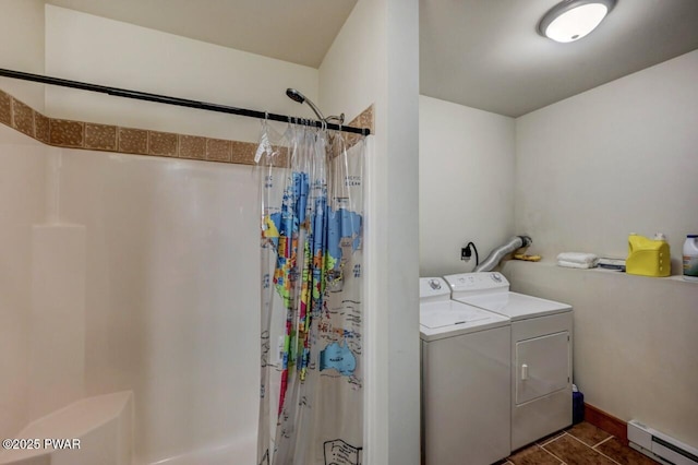 laundry area with washer and clothes dryer, baseboards, dark tile patterned floors, and a baseboard radiator