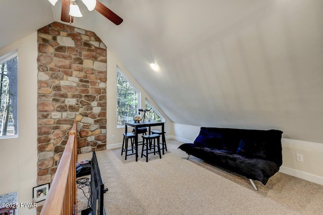 living area featuring baseboards, carpet, a ceiling fan, and vaulted ceiling