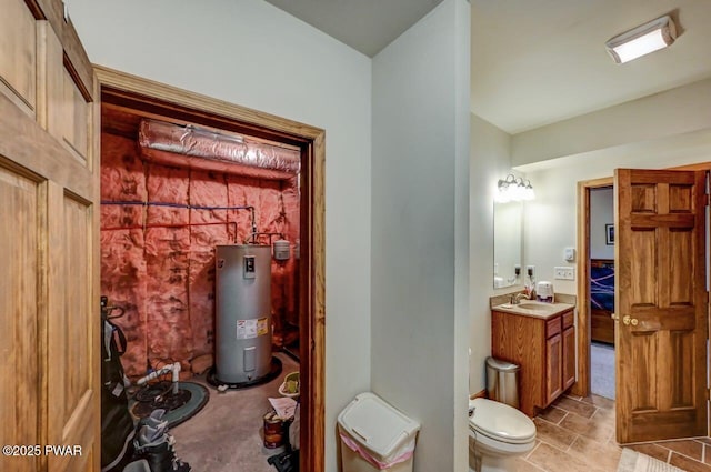 bathroom featuring electric water heater, vanity, and toilet