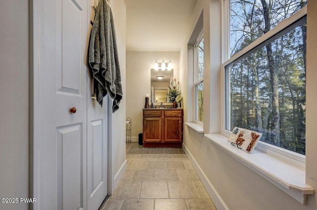 bathroom featuring baseboards and vanity