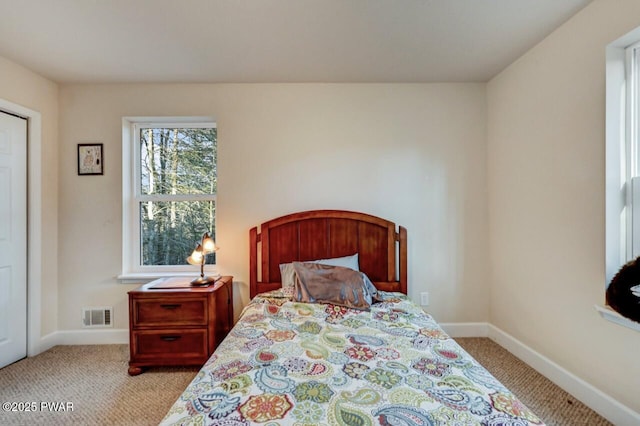 bedroom with visible vents, carpet floors, and baseboards