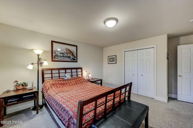 carpeted bedroom with baseboards and a closet