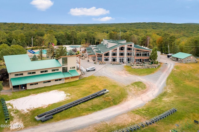 drone / aerial view with a wooded view