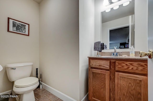 bathroom featuring tile patterned floors, toilet, vanity, and baseboards