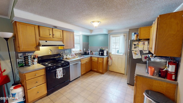 kitchen with brown cabinetry, range hood, appliances with stainless steel finishes, and light countertops