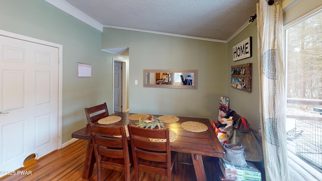 dining area featuring crown molding, a textured ceiling, and wood finished floors