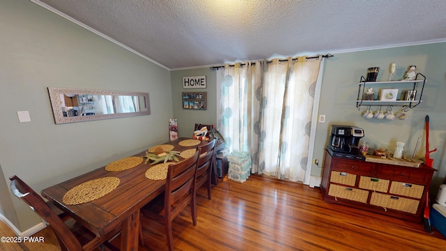 dining space featuring lofted ceiling, crown molding, dark wood-style floors, and a healthy amount of sunlight