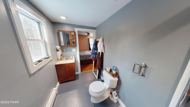 bathroom featuring ensuite bathroom, toilet, vanity, and baseboards