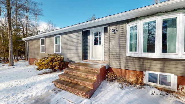 view of snow covered property entrance