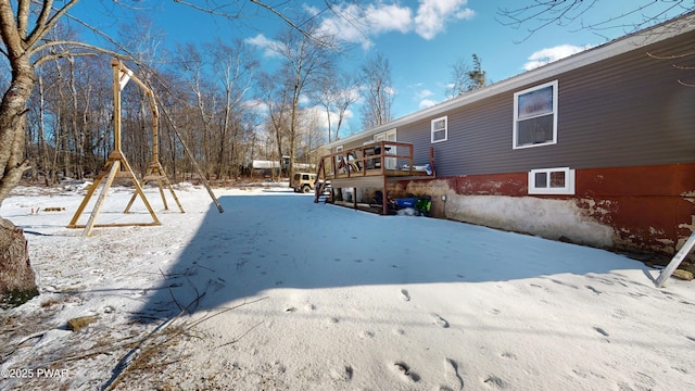 yard layered in snow featuring a deck