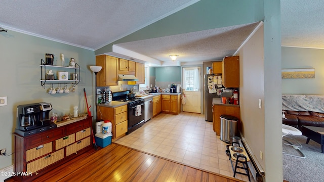 kitchen featuring appliances with stainless steel finishes, light countertops, under cabinet range hood, and a textured ceiling