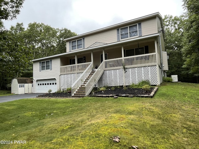 view of front of property with a porch, a garage, an outdoor structure, and a front lawn