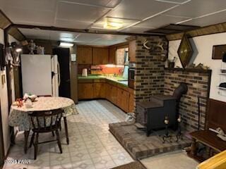 195 Conashaugh Trl, Milford, PA 18337 - kitchen featuring freestanding refrigerator, brown cabinets, and a wood stove