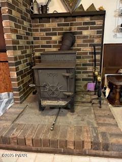 195 Conashaugh Trl, Milford, PA 18337 - detailed view of a wood stove and brick wall