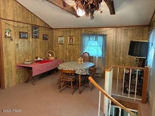 195 Conashaugh Trl, Milford, PA 18337 - carpeted dining area featuring wood walls and lofted ceiling