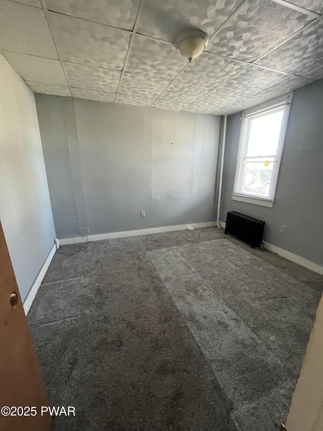 1021 Fellows St, Scranton, PA 18504 - carpeted empty room with radiator heating unit and a paneled ceiling