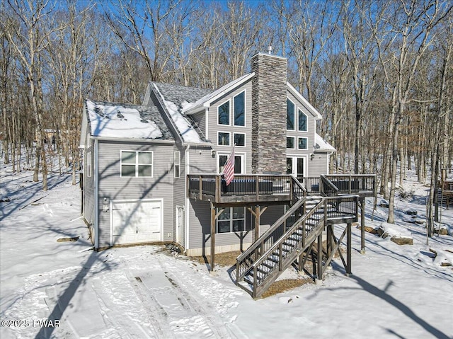 view of front facade featuring a garage and a wooden deck