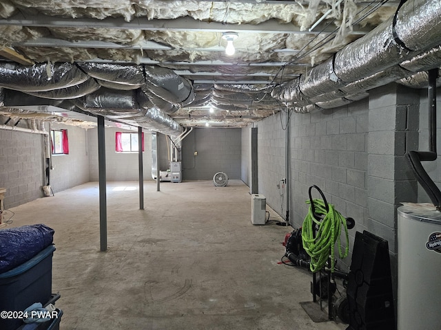 basement featuring gas water heater and heating unit